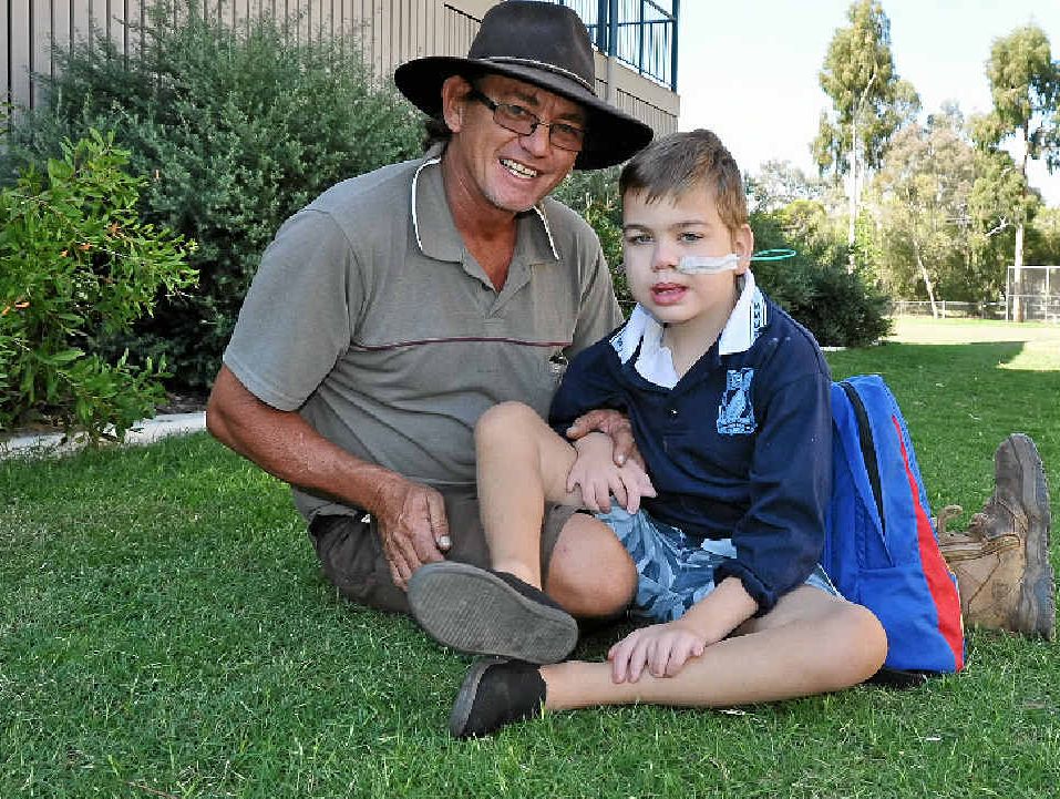 Father Phil Bowles with 8-year-old Angus who is one of only 165 people world-wide diagnosed with Pallister-Hall Syndrome. Father Phil Bowles with 8-year-old Angus who is one of only 165 people world-wide diagnosed with Pallister-Hall Syndrome.